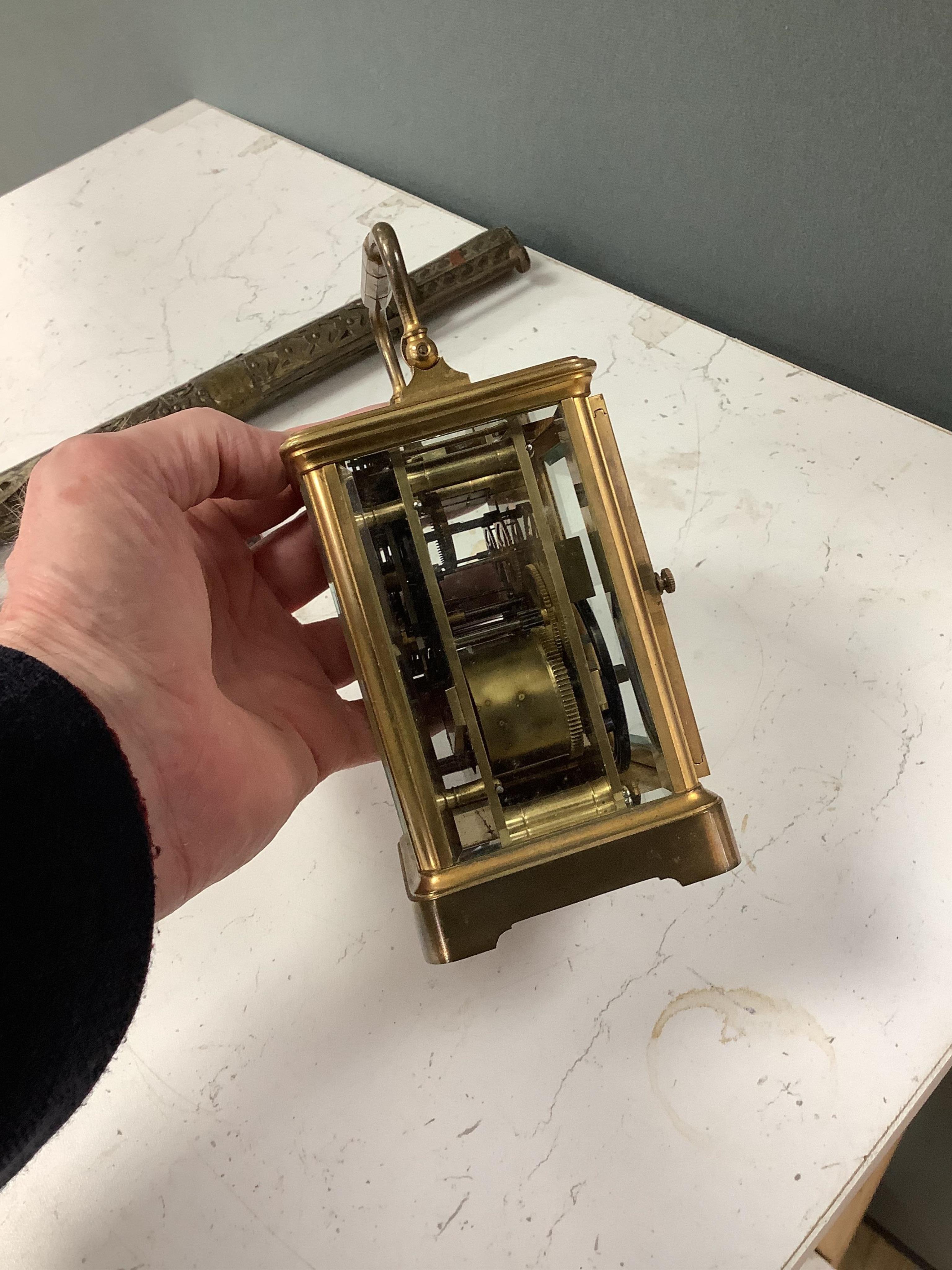 A late 19th century lacquered brass repeating carriage clock, by Henri Jacot and an Edwardian inlaid mantel timepiece with key, largest 23cm high